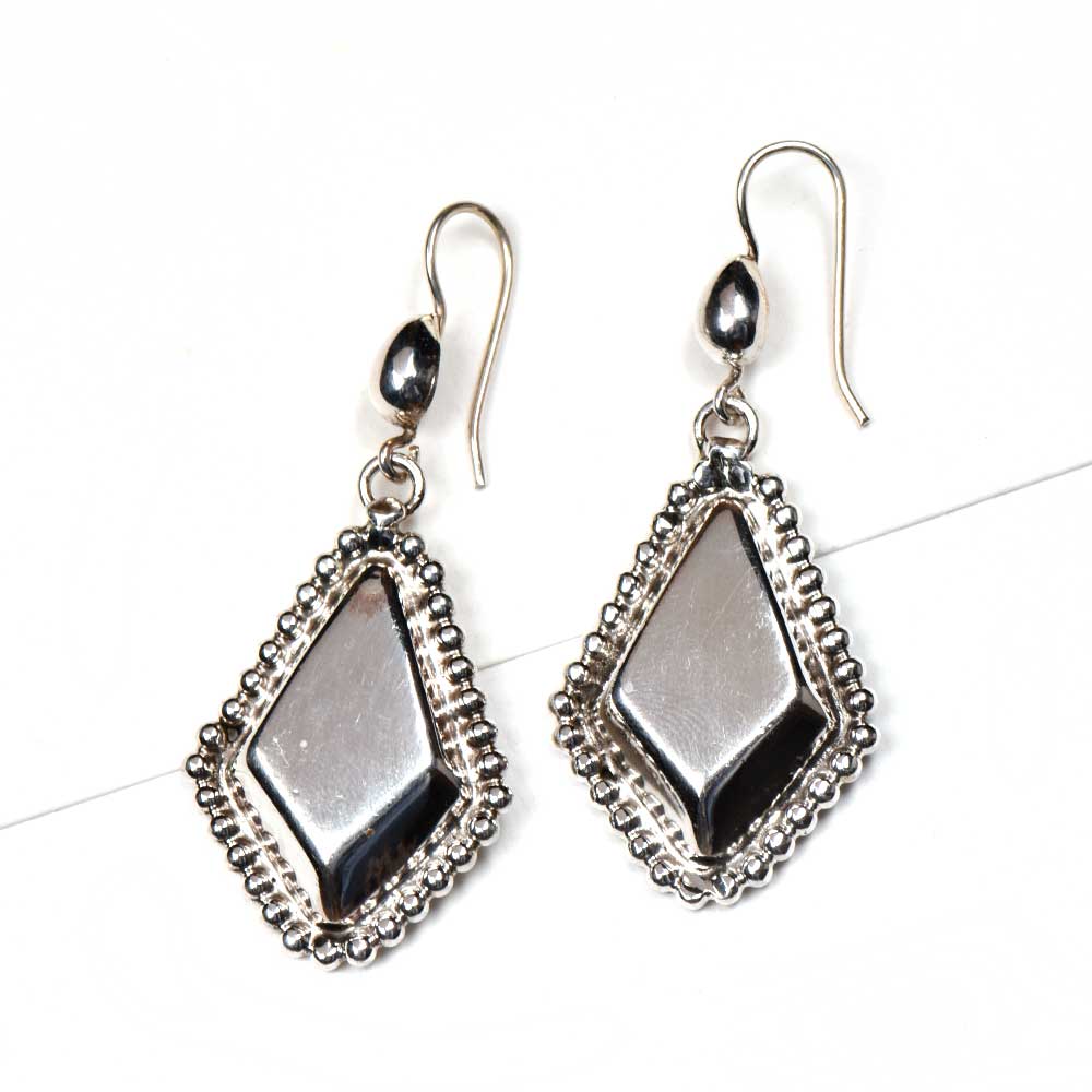 Angle view of Reet earrings capturing the shine of 92.5 Sterling Silver