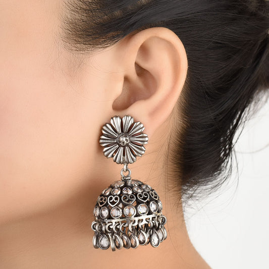 Pair of 92.5 sterling silver floral jhumki earrings displayed elegantly