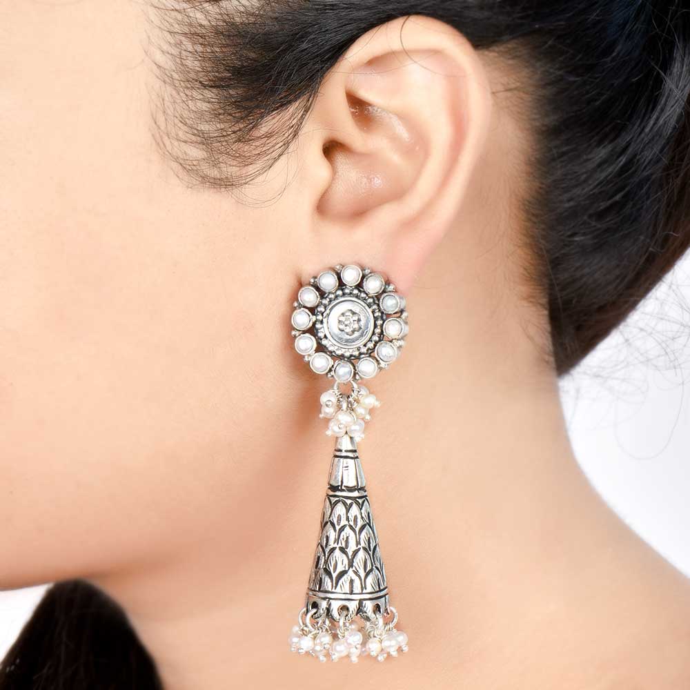 Front view of Reet pearl dangle earrings in 92.5 Sterling Silver