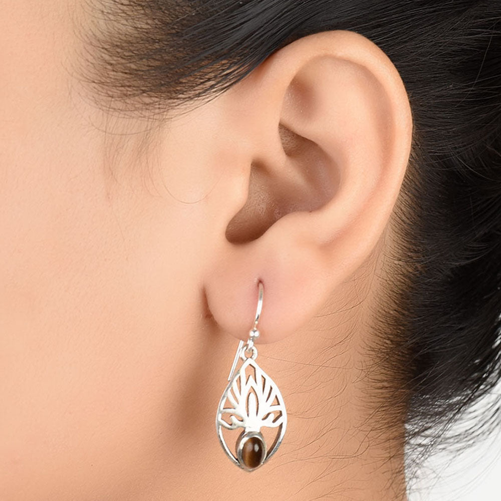 Pair of 92.5 sterling silver tiger eye stone dangle earrings displayed elegantly