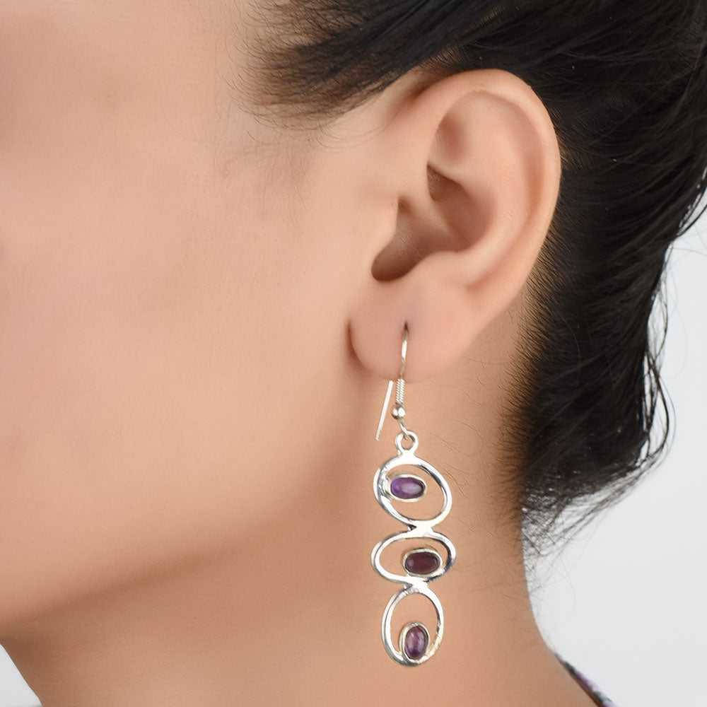 Model wearing Amethyst Dangle Earrings, highlighting size and 92.5 Sterling Silver.