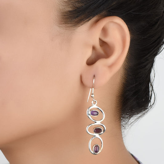 Model wearing Amethyst Dangle Earrings, highlighting size and 92.5 Sterling Silver.