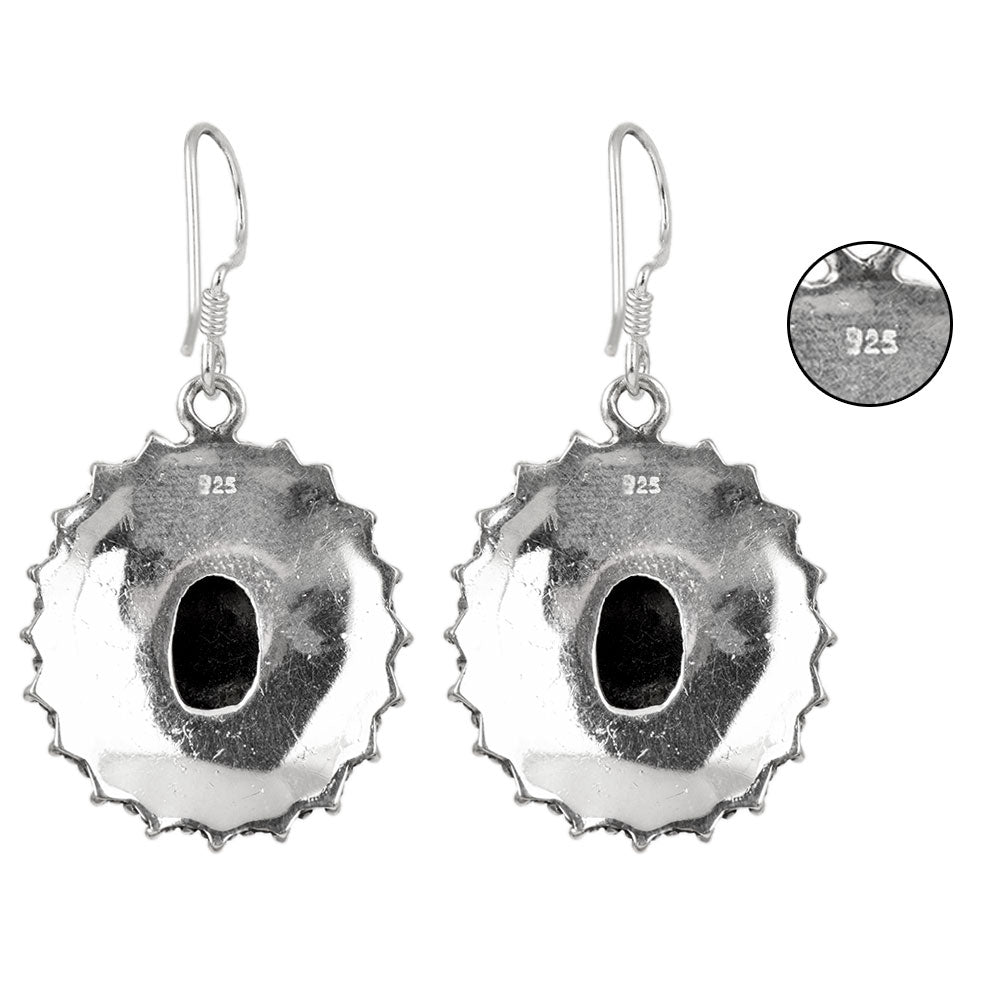 Side angle showing drop dangle black earrings with black , silver tones.