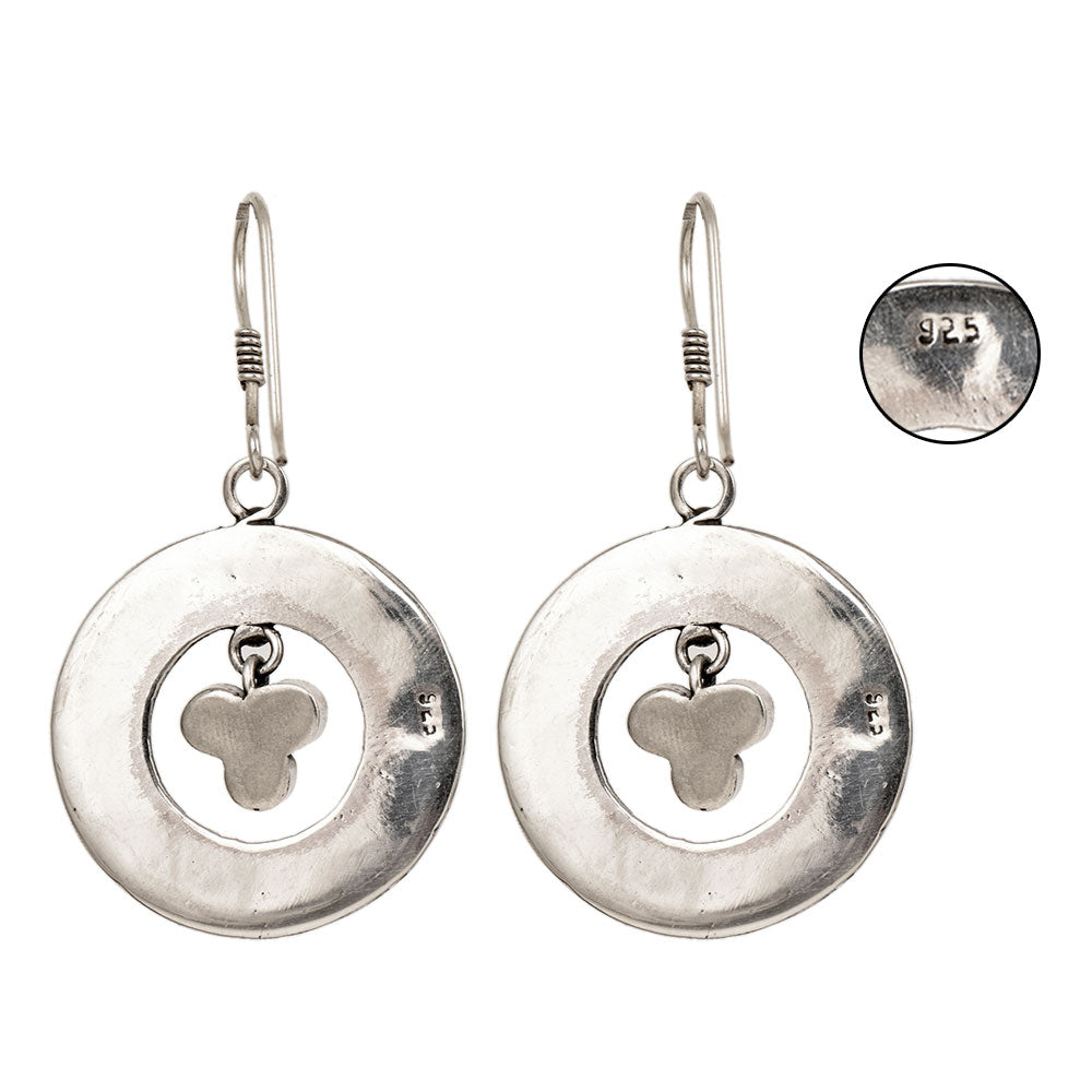 Side angle showing lapis earrings with silver tones.