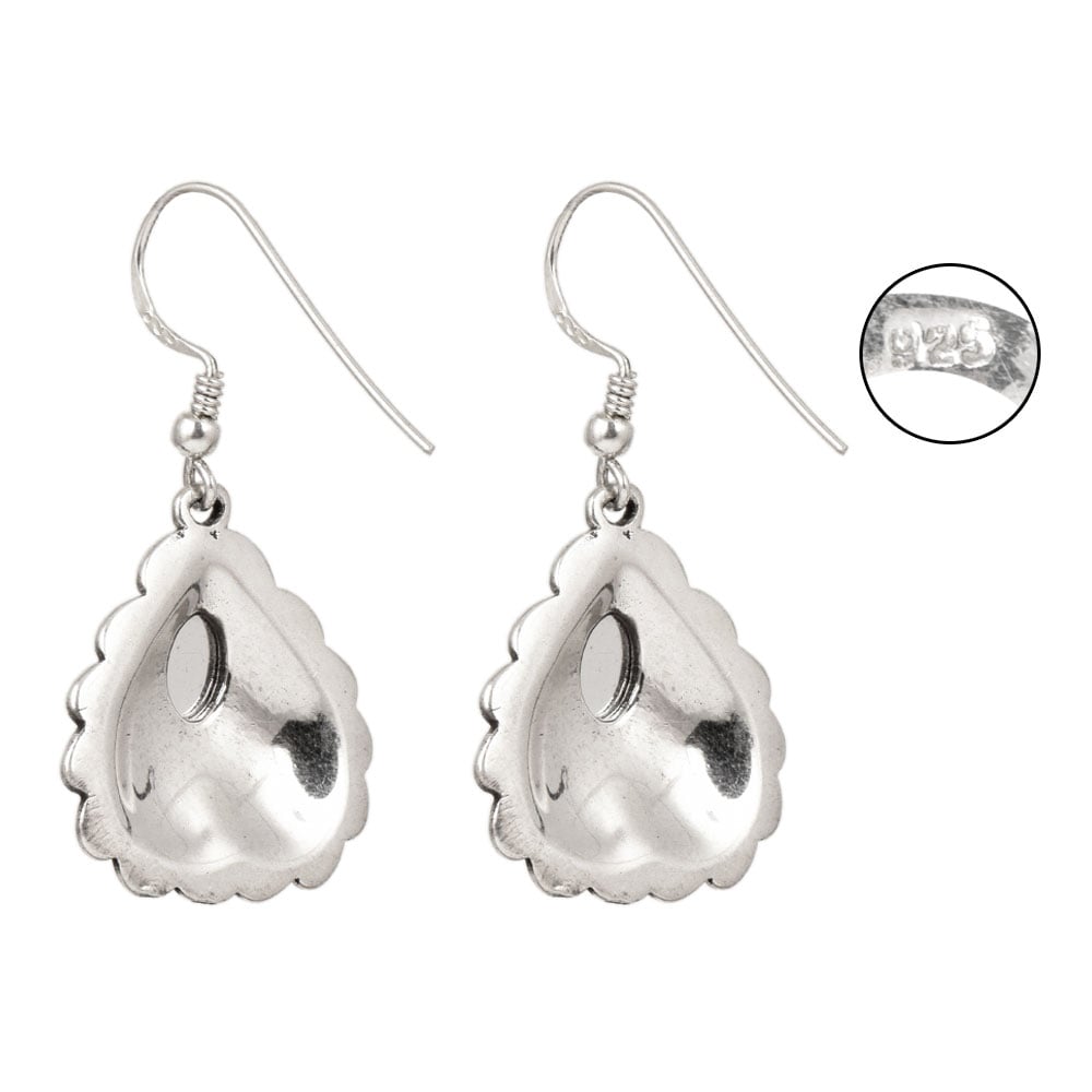 Side angle showing heart red stone dangle earrings with red , silver tones.