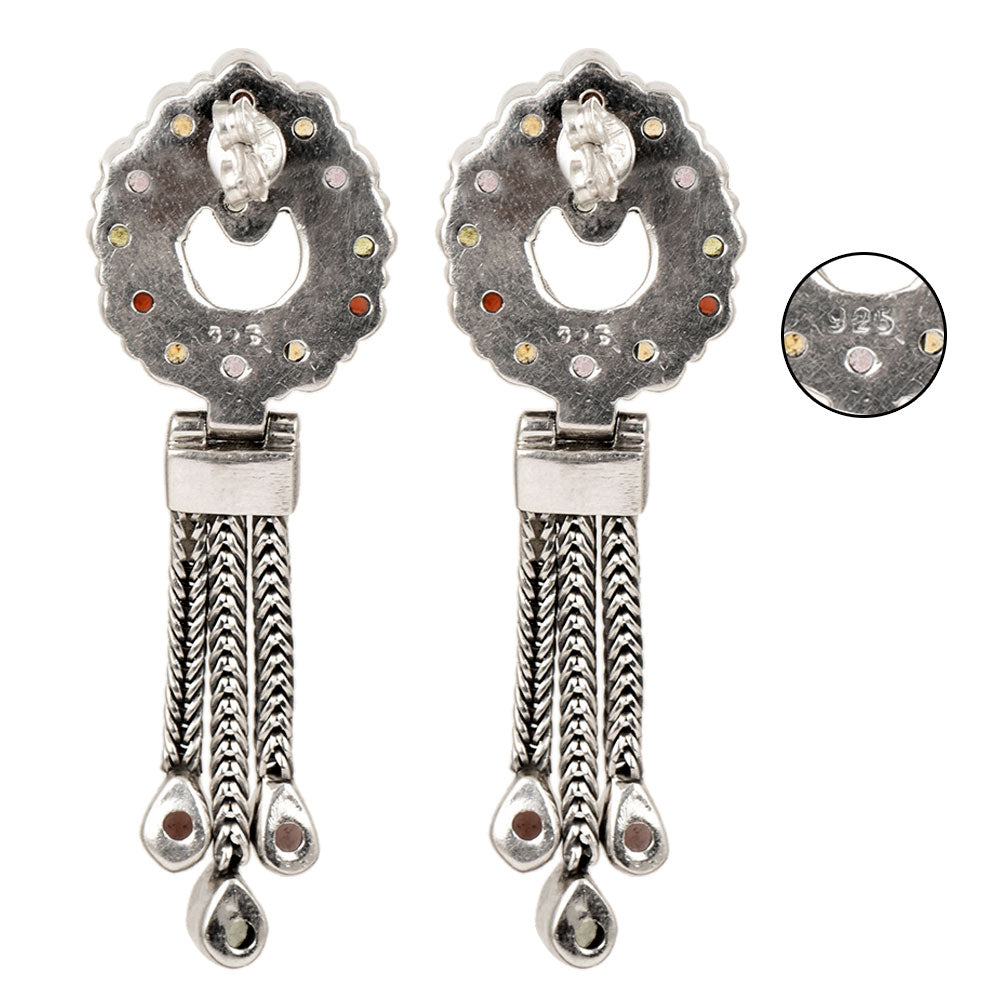 Side angle showing tassel drop colored drop earrings with multicolor tones.