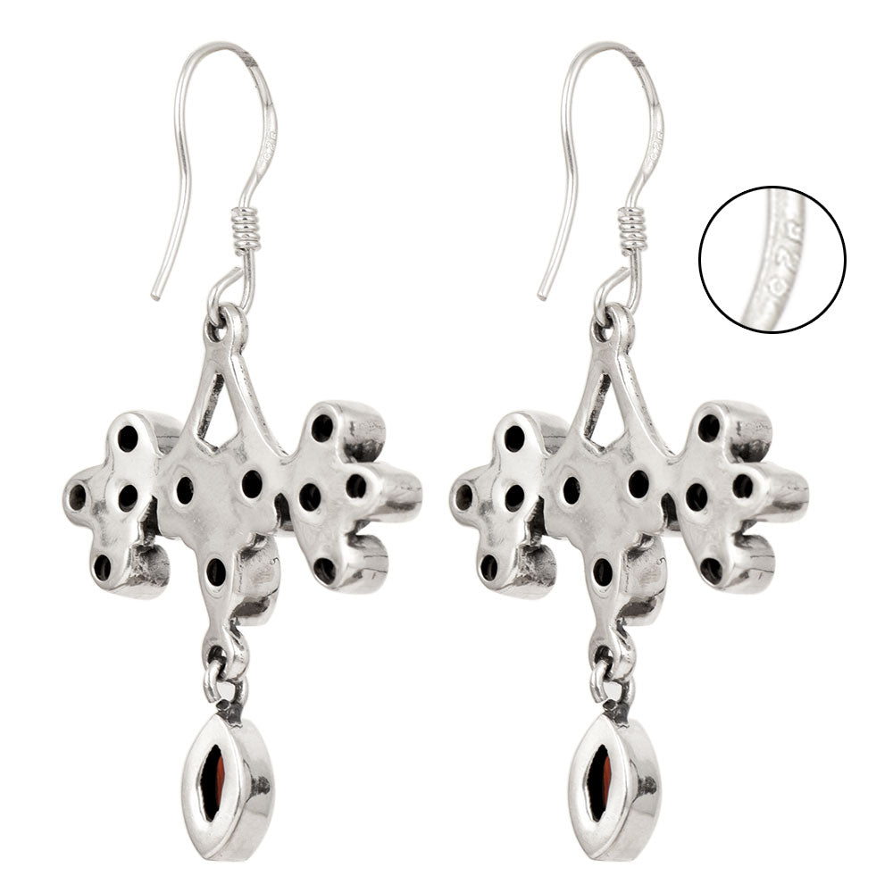 Side angle showing garnet earrings with red , silver tones.