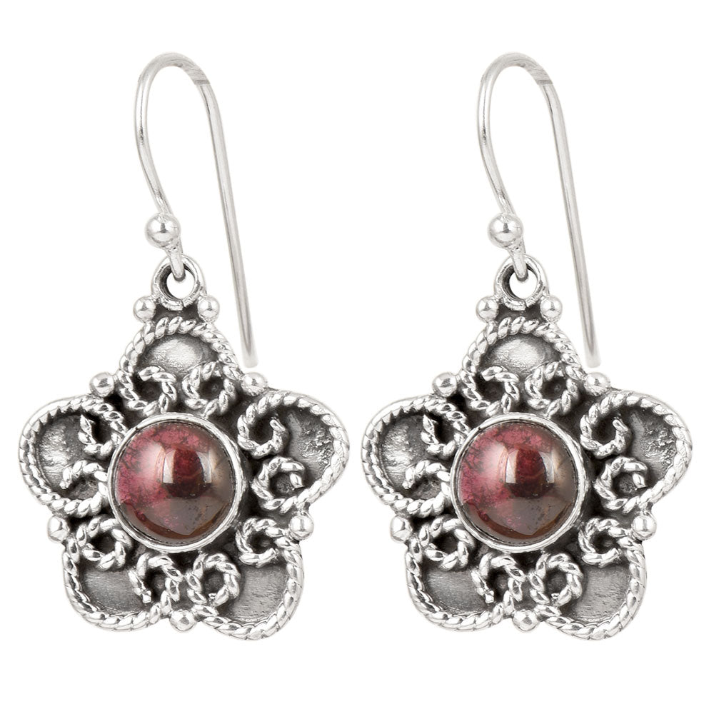 Side angle showing jade floral dangle earrings with silver tones.