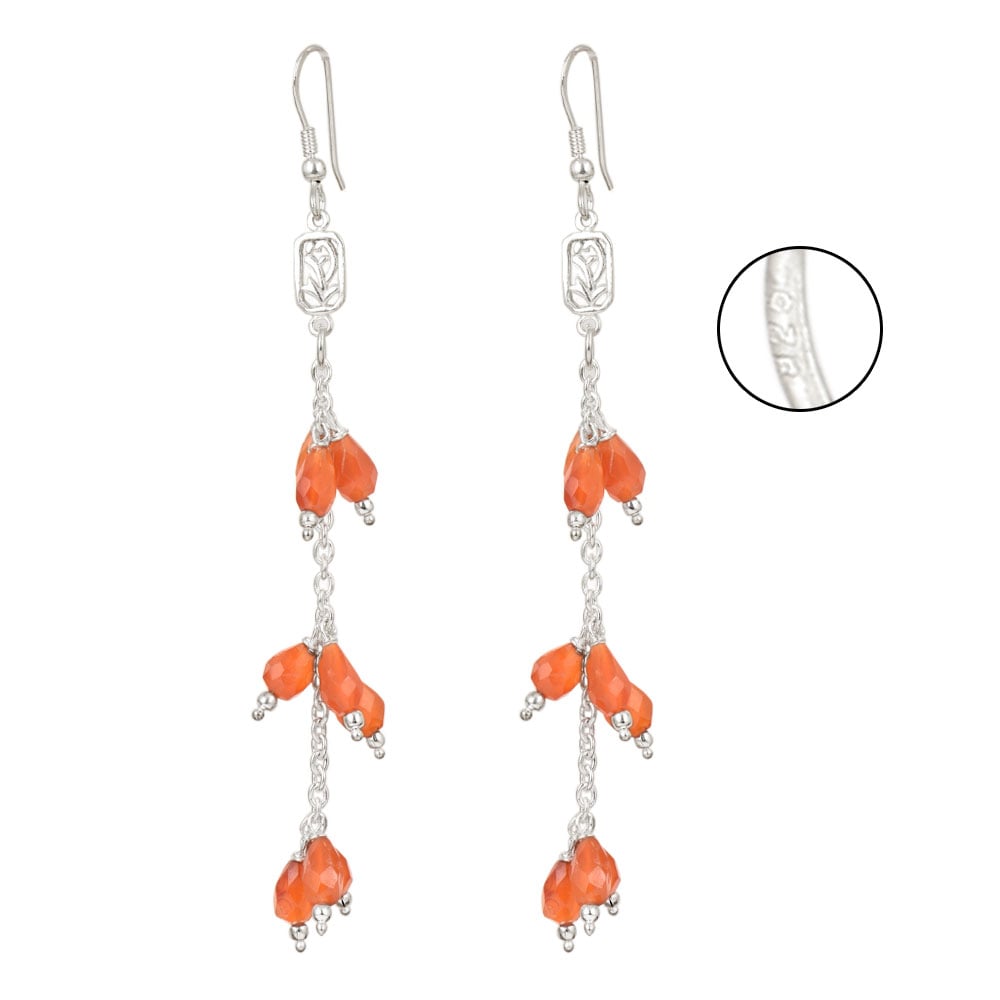 Side angle showing carnelian earrings with silver tones.