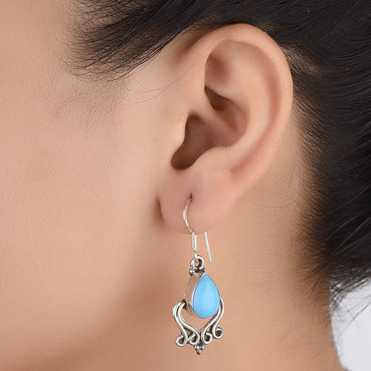 Front view of Neela Turquoise turquoise dangle earrings crafted in 92.5 Sterling Silver.