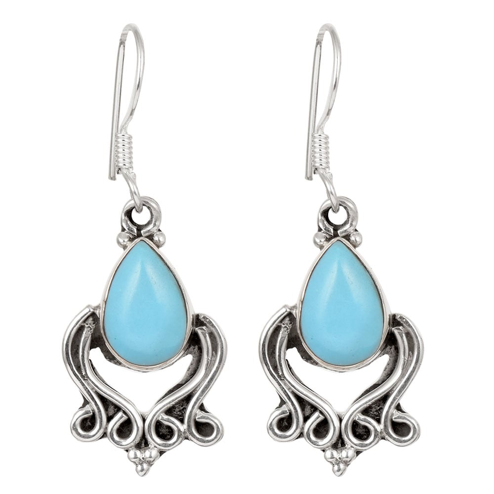 Side angle showing turquoise dangle earrings with silver , turquoise tones.