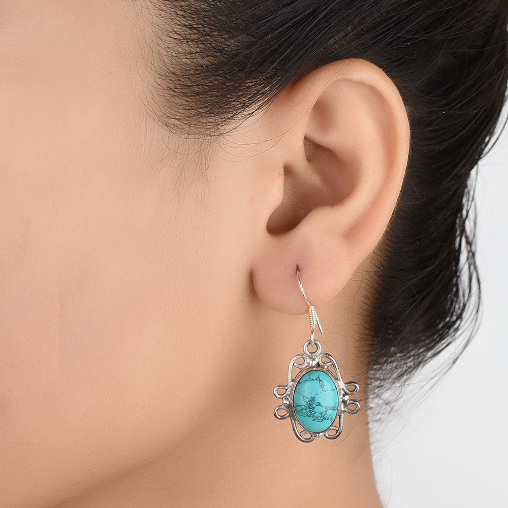 Front view of Neela Turquoise turquoise dangle earrings crafted in 92.5 Sterling Silver.