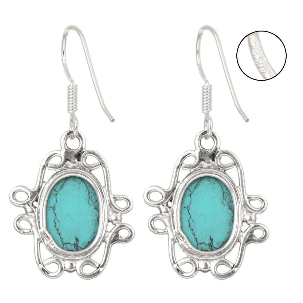 Side angle showing turquoise dangle earrings with silver tones.