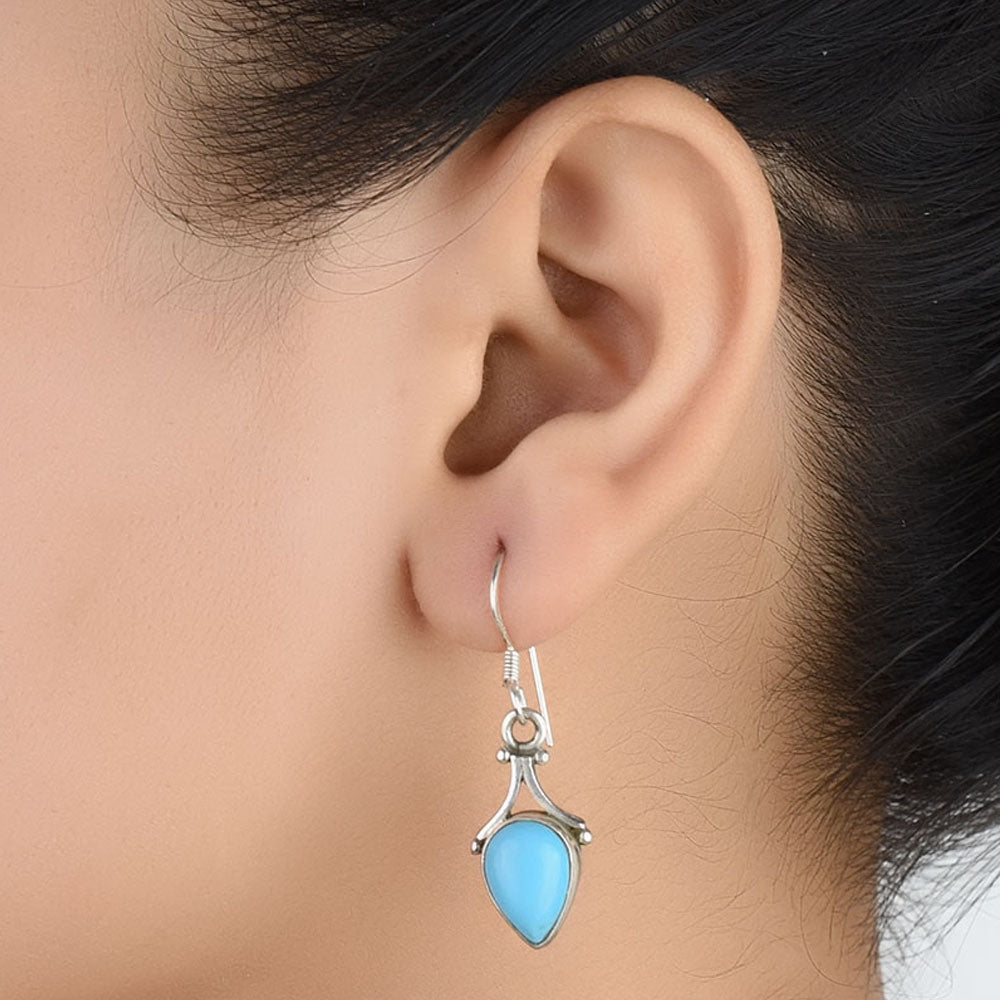 Pair of Turquoise Teardrop Earrings displayed on a neutral background for a clear view.