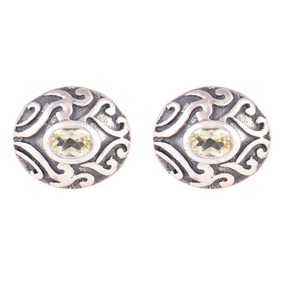 Reet stud earrings resting on fabric, showing enamel stone fashion and subtle handwork.