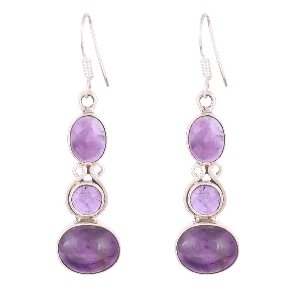 Jamuni Amethyst dangle earrings resting on fabric, showing amethyst and subtle handwork.