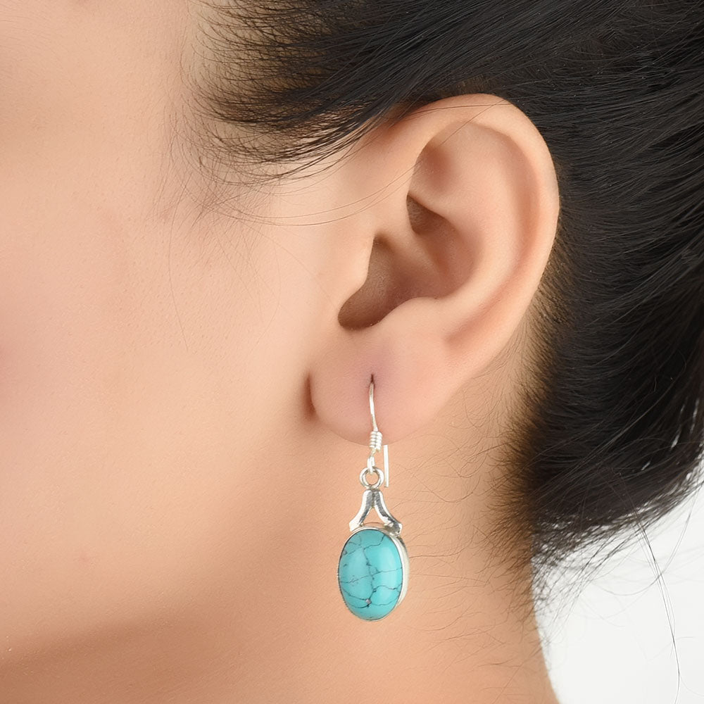 Close-up of the intricate design on Turquoise Dangle Earrings with Silver and Turquoise accents in 92.5 Sterling Silver.