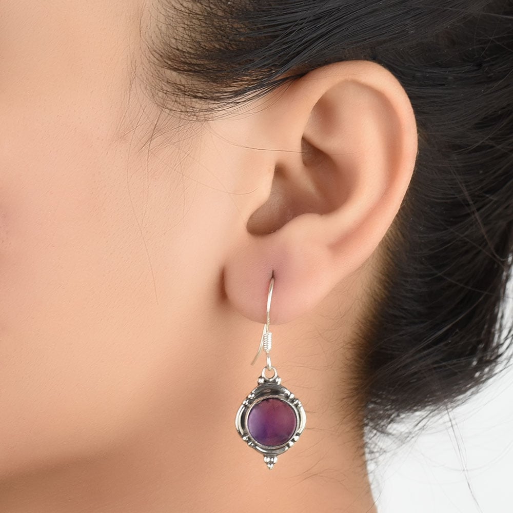 Round earrings with amethyst in 92.5 Sterling Silver, hand-finished and inspired by carved windows.