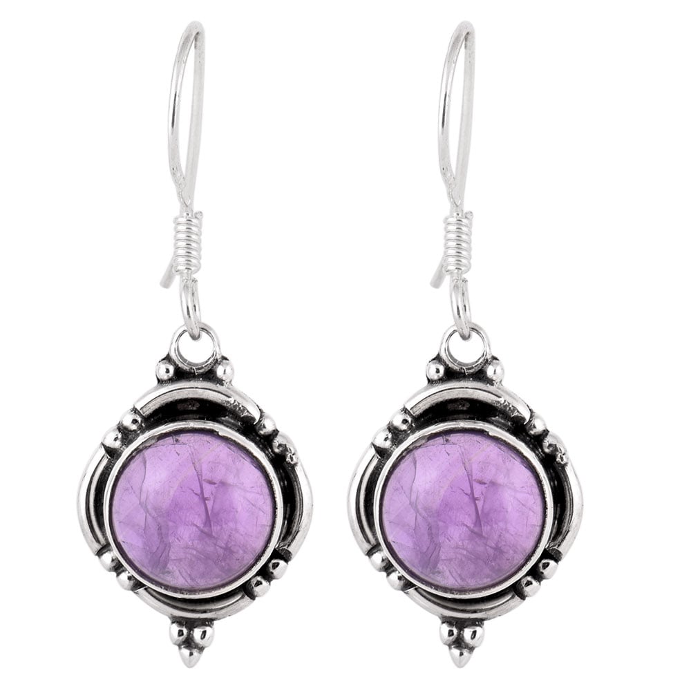 Jamuni Amethyst round earrings resting on fabric, showing amethyst and subtle handwork.