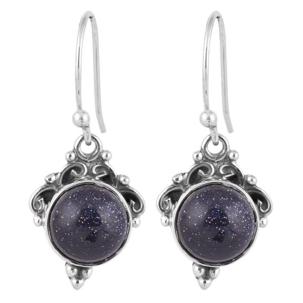 Reet wire earrings resting on fabric, showing blue goldstone and subtle handwork.