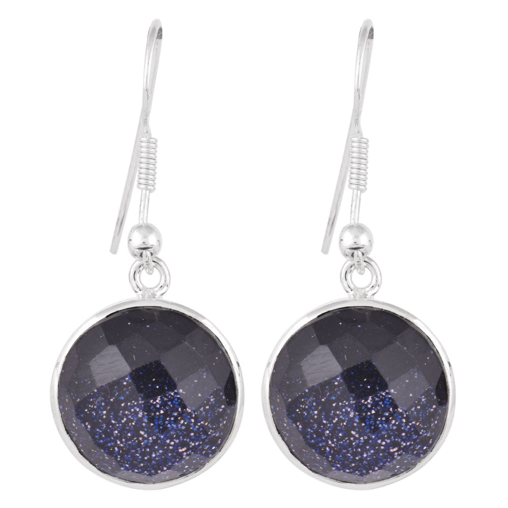 Reet earrings resting on fabric, showing faceted blue goldstone and subtle handwork.