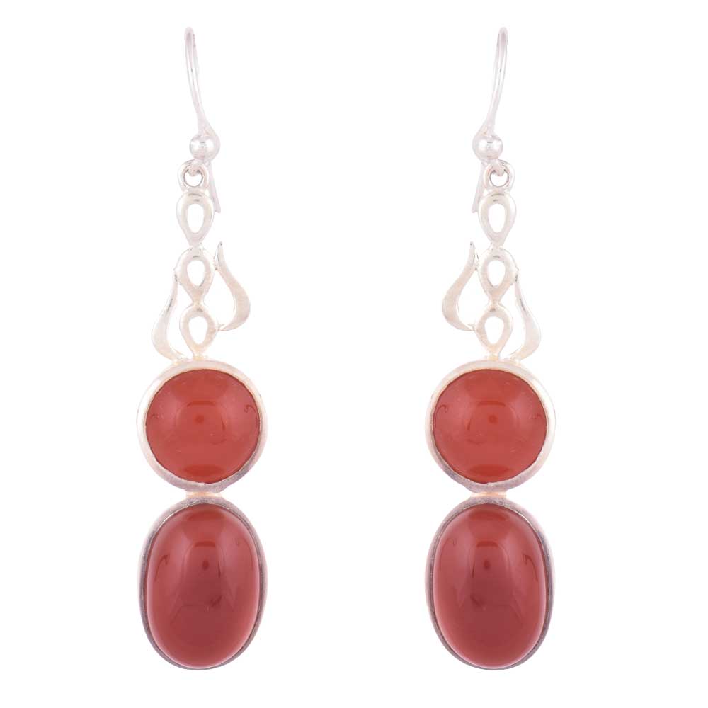 Hari Jade earrings resting on fabric, showing jade and subtle handwork.