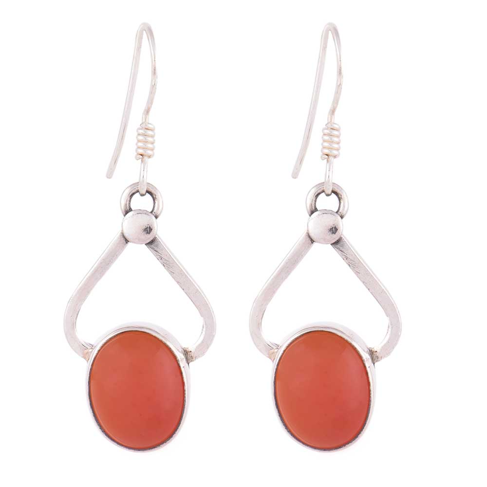 Laal Carnelian oval earrings resting on fabric, showing carnelian and subtle handwork.