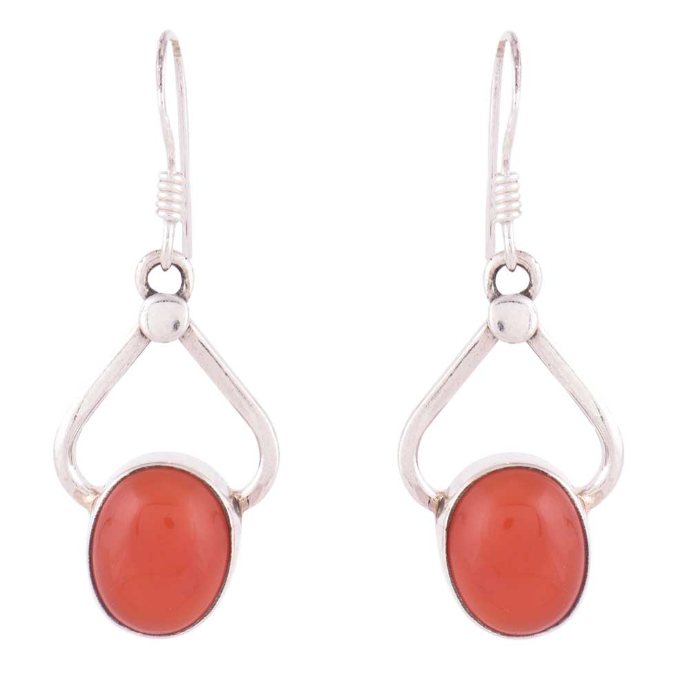 Laal Carnelian earrings resting on fabric, showing carnelian and subtle handwork.