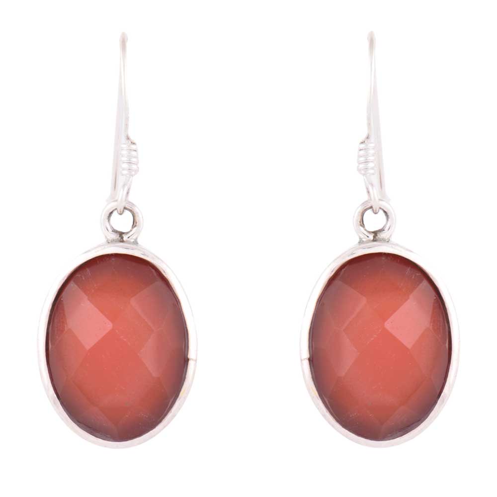 Hari Jade earrings resting on fabric, showing jade and subtle handwork.