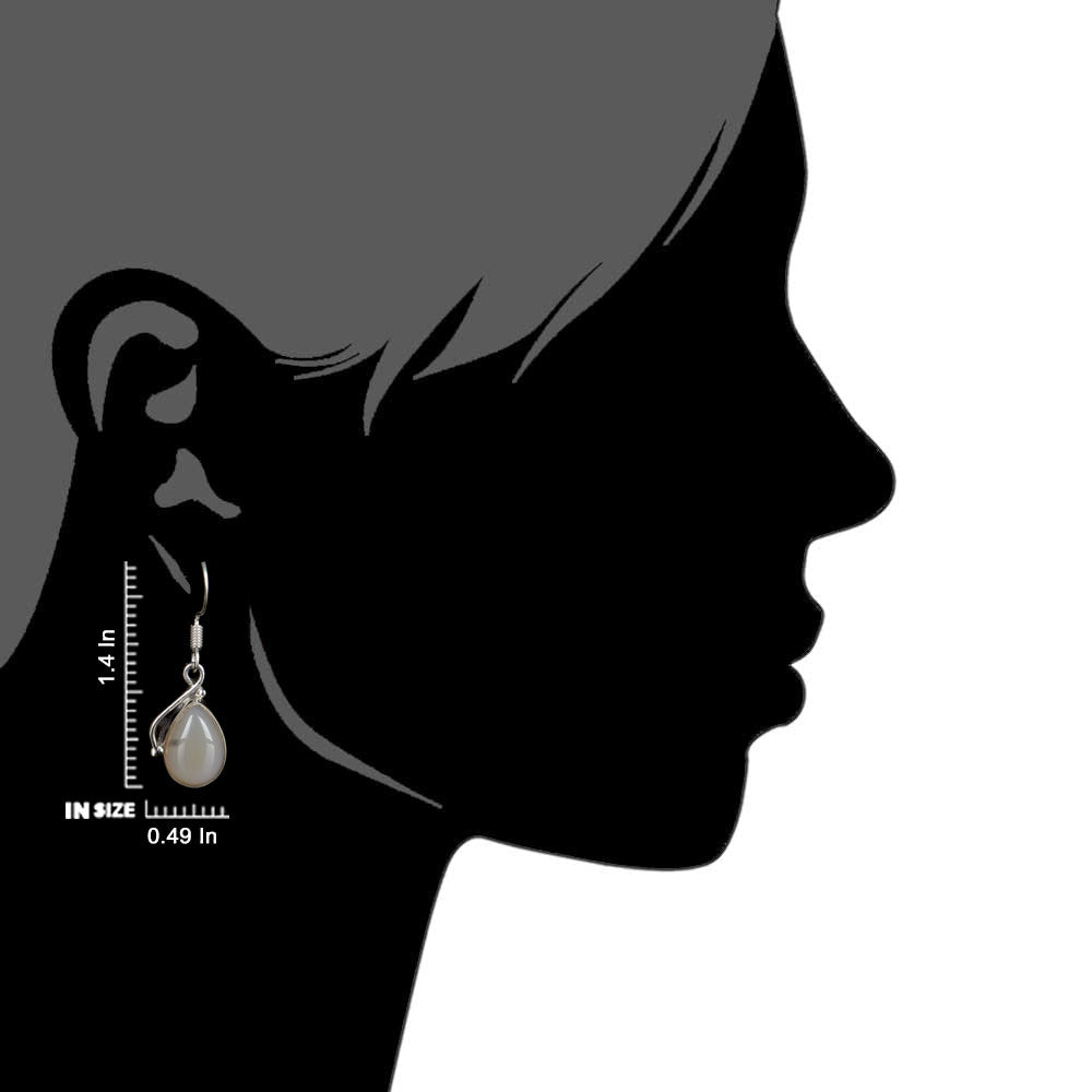 Side view of the artisan made Moonstone Moon Dangle Earrings revealing the texture and light play