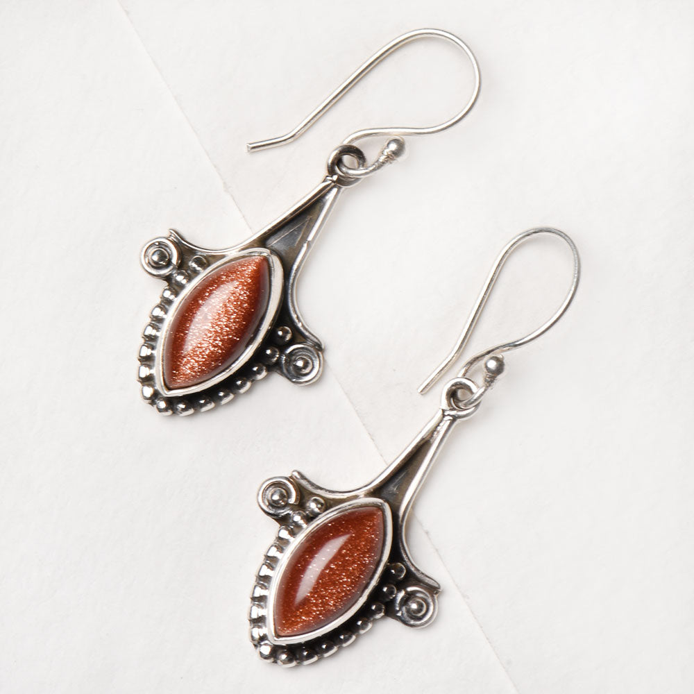 Closeup of Sun Stone Fish Dangle Earrings showcasing the detailed dangle motif and 92.5 Sterling Silver finish