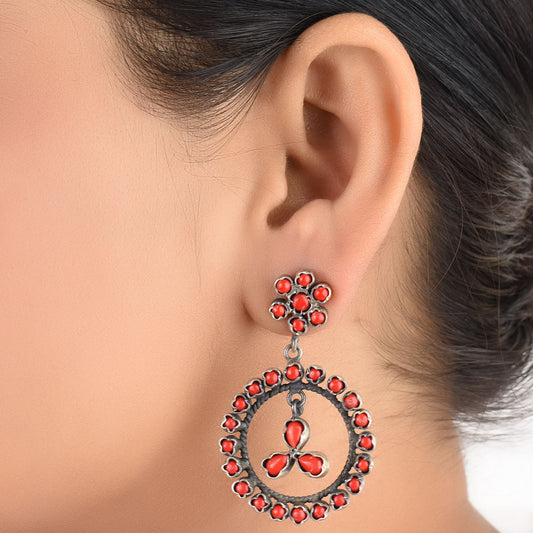 Coral round dangle earrings in 925 sterling silver worn close to the ear
