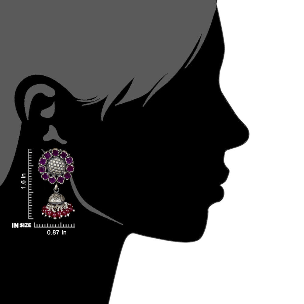 Close-up of pink tourmaline earrings featuring sun detailing