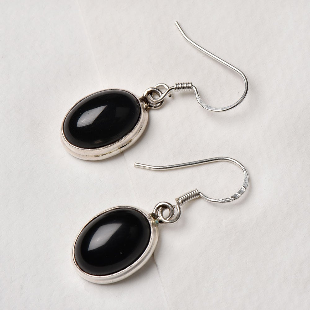 Closeup of Black Onyx Oval Drop Earrings showcasing the detailed drop motif and 92.5 Sterling Silver finish