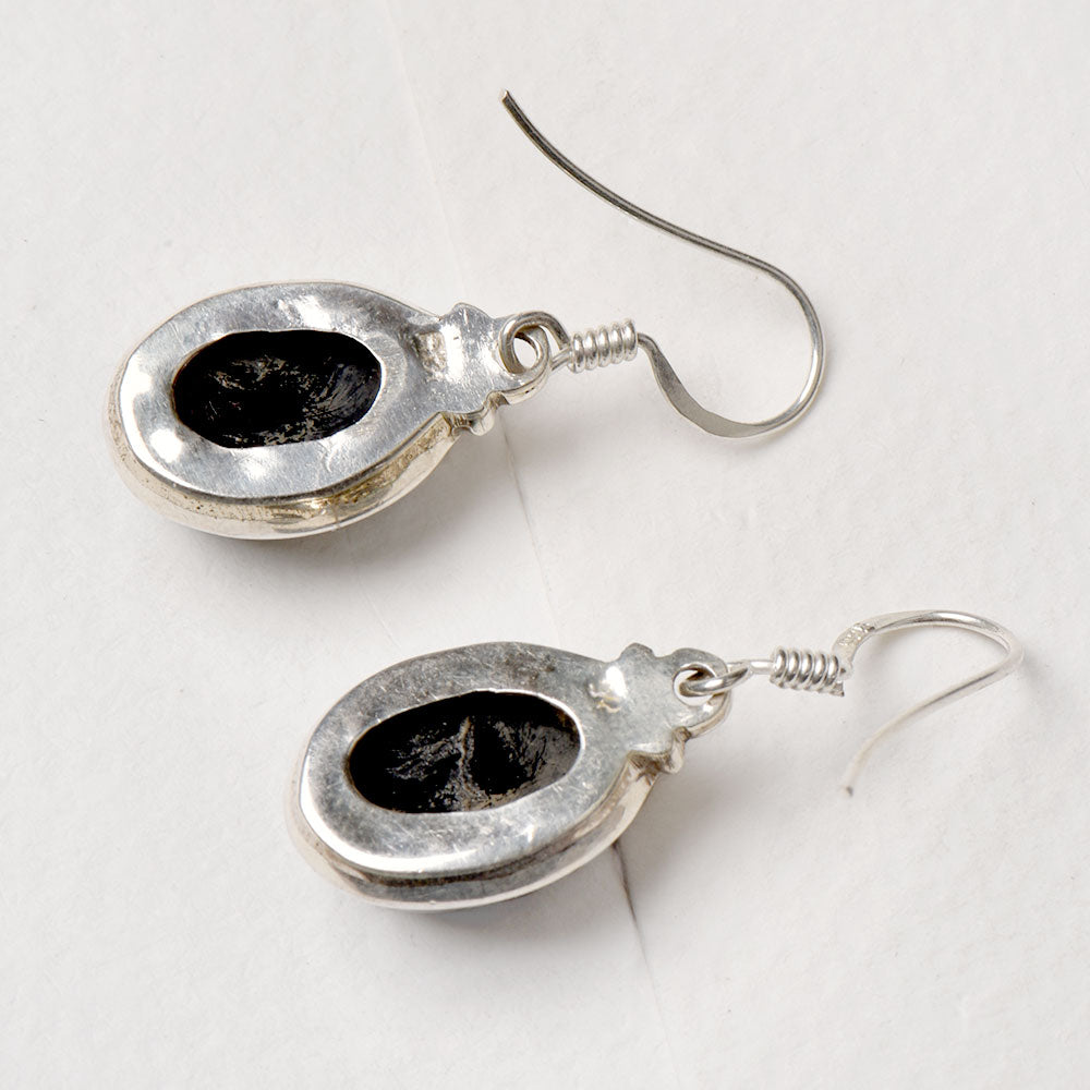 Side view of the artisan made Black Onyx Drop Earrings revealing the texture and light play
