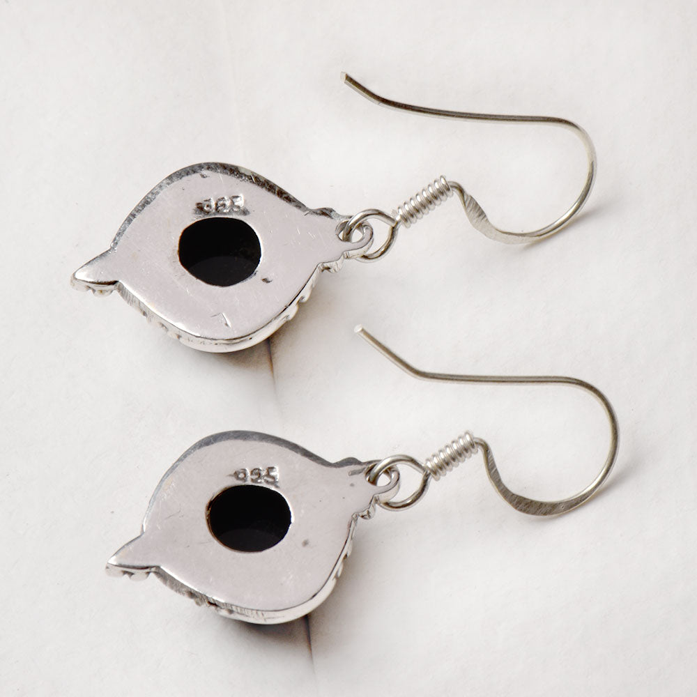 Side view of the artisan made Black Onyx Round Drop Earrings revealing the texture and light play