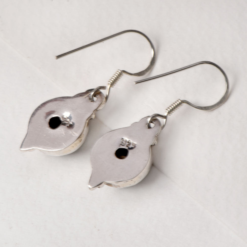 Side view of the artisan made Black Onyx Round Drop Earrings revealing the texture and light play