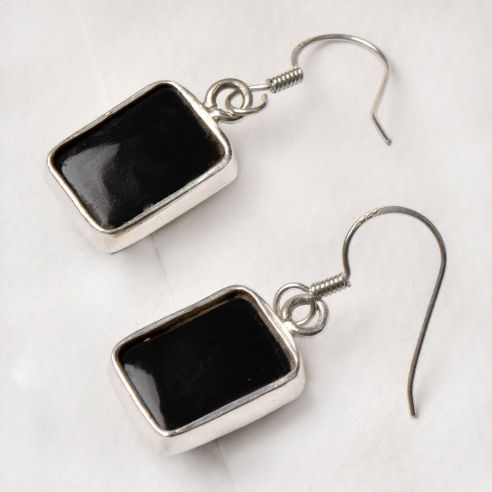 Side view of the artisan made Black Onyx Square Earrings revealing the texture and light play