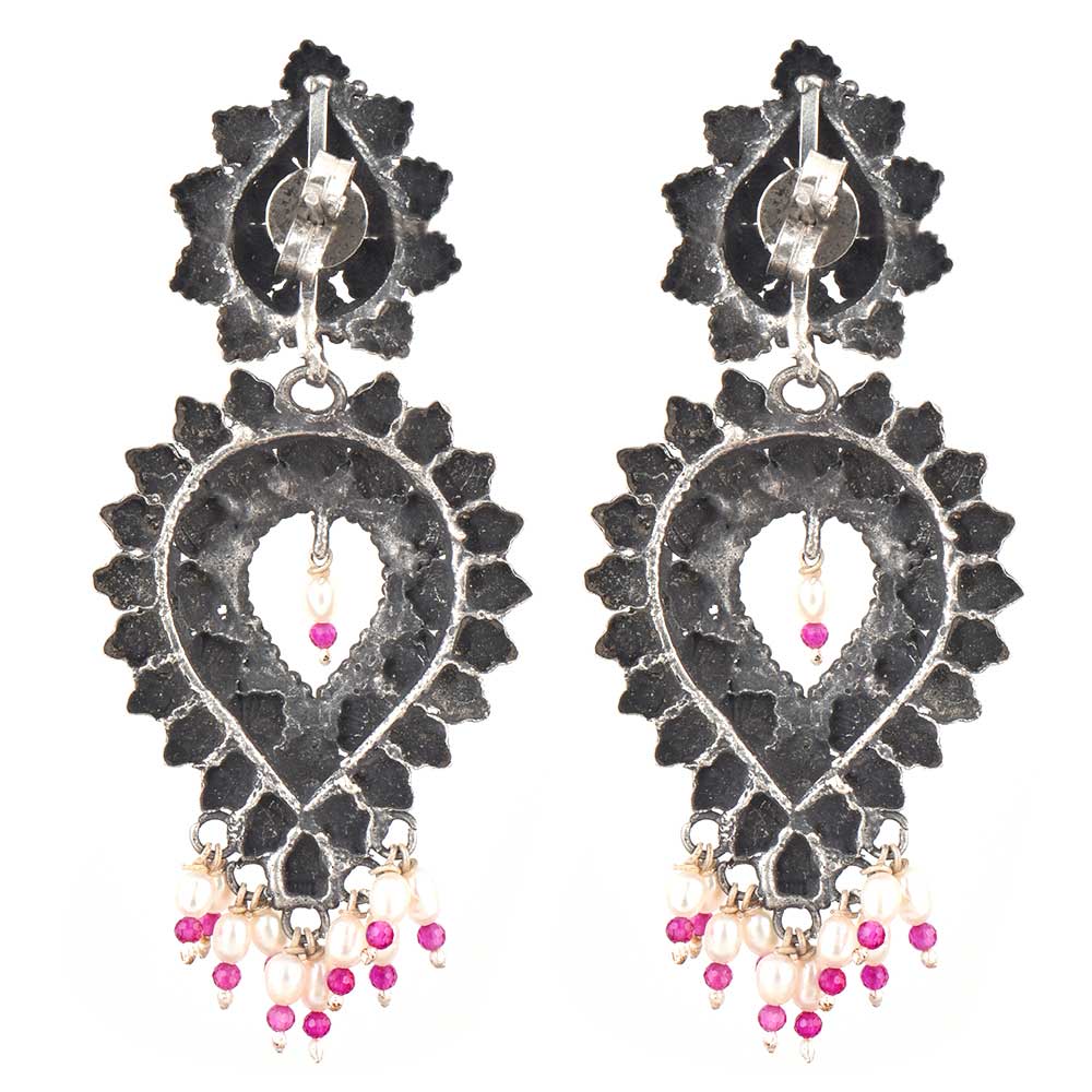 Close-up of intricate floral engraving with sapphire pearl accents