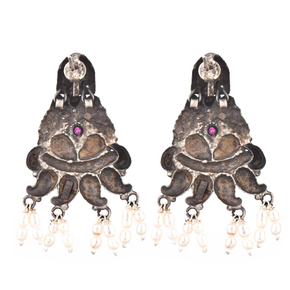 Close-up of intricate peacock engraving with amethyst accents