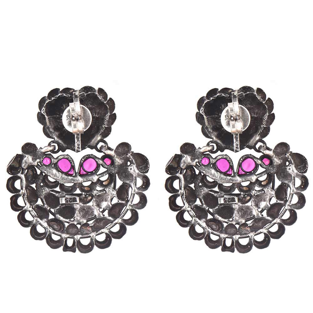 Close-up of intricate engraved and chandbali and crescent and butterfly engraving with jade accents