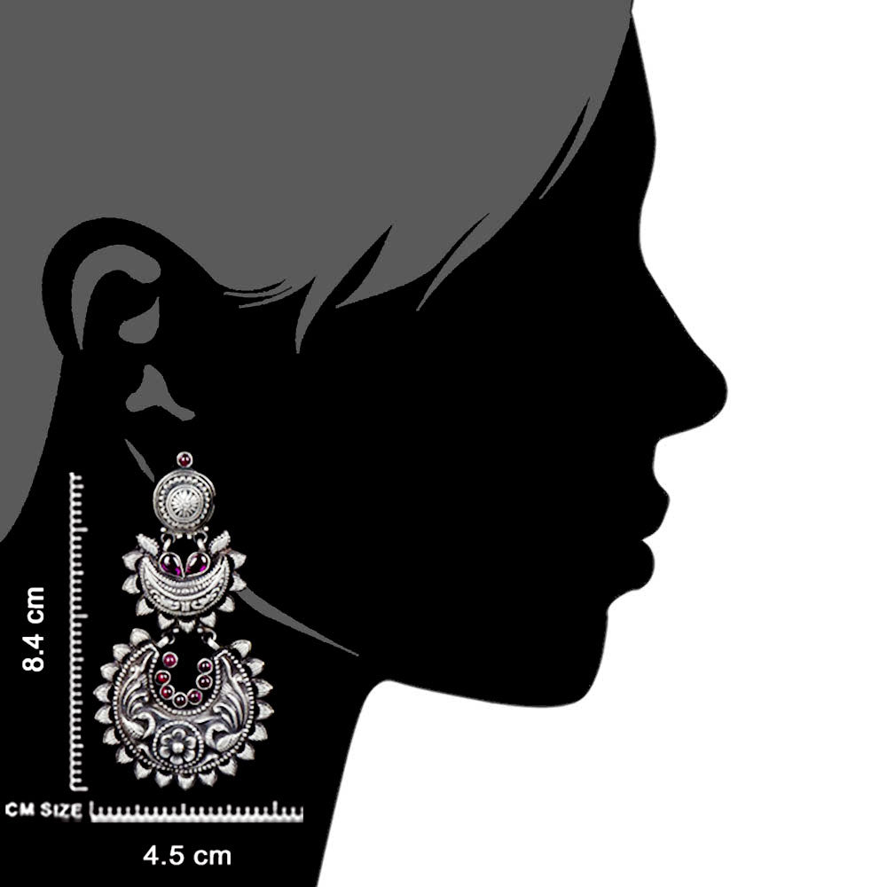 Artisan hands crafting the peacock dangle earrings