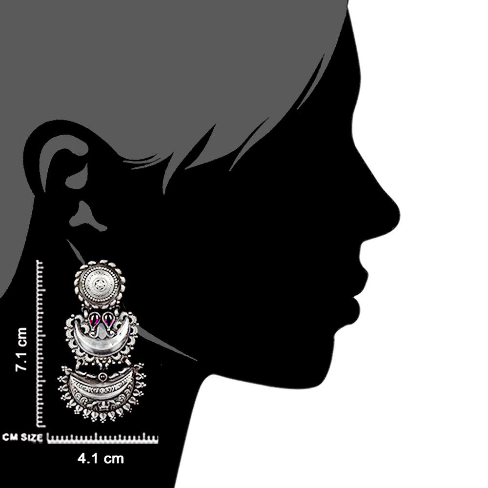 Artisan hands crafting the crescent stud earrings