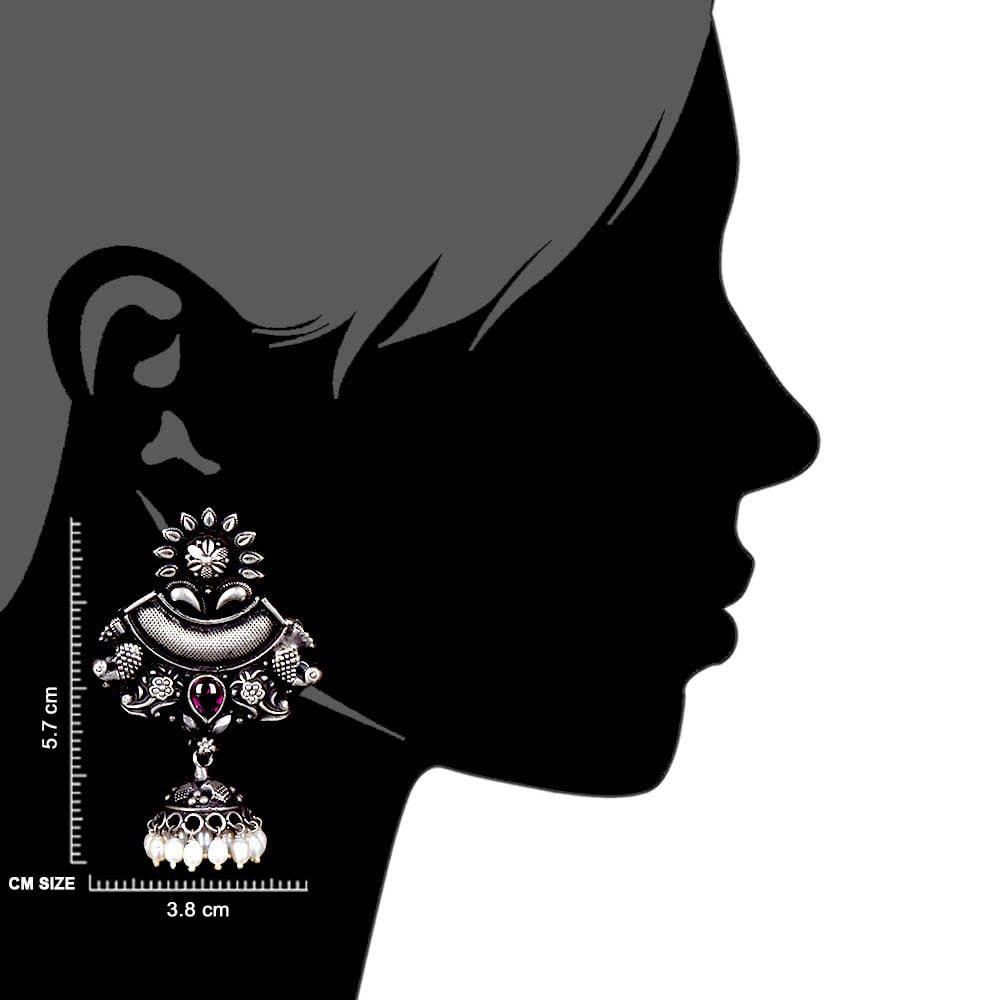 Artisan hands crafting the tribal dangle earrings