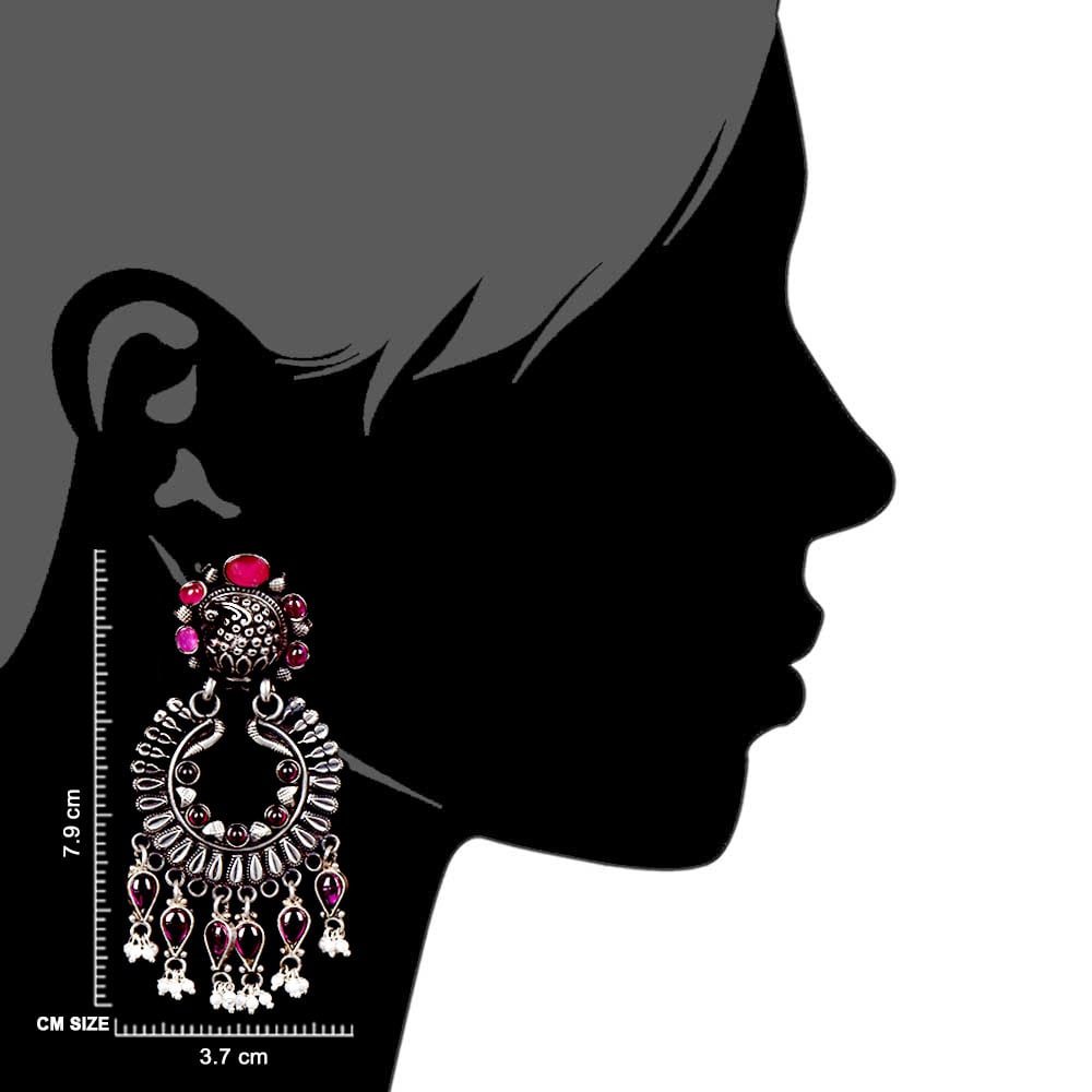 Artisan hands crafting the floral earrings