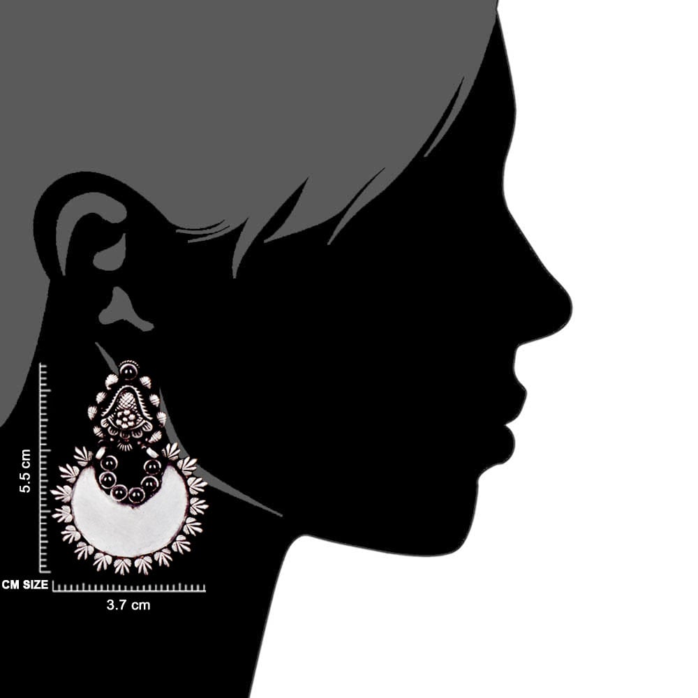 Artisan hands crafting the crescent dangle earrings