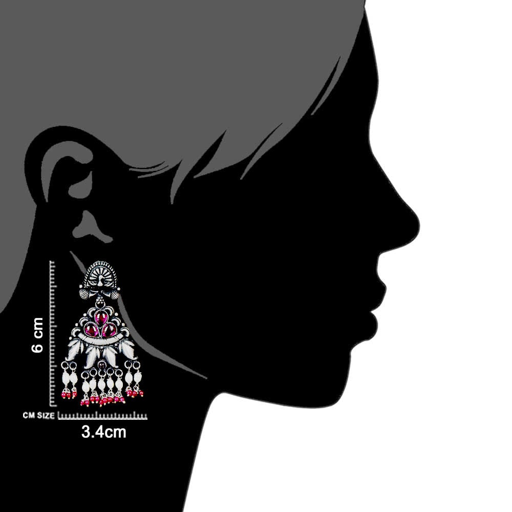 Artisan hands crafting the peacock stud earrings