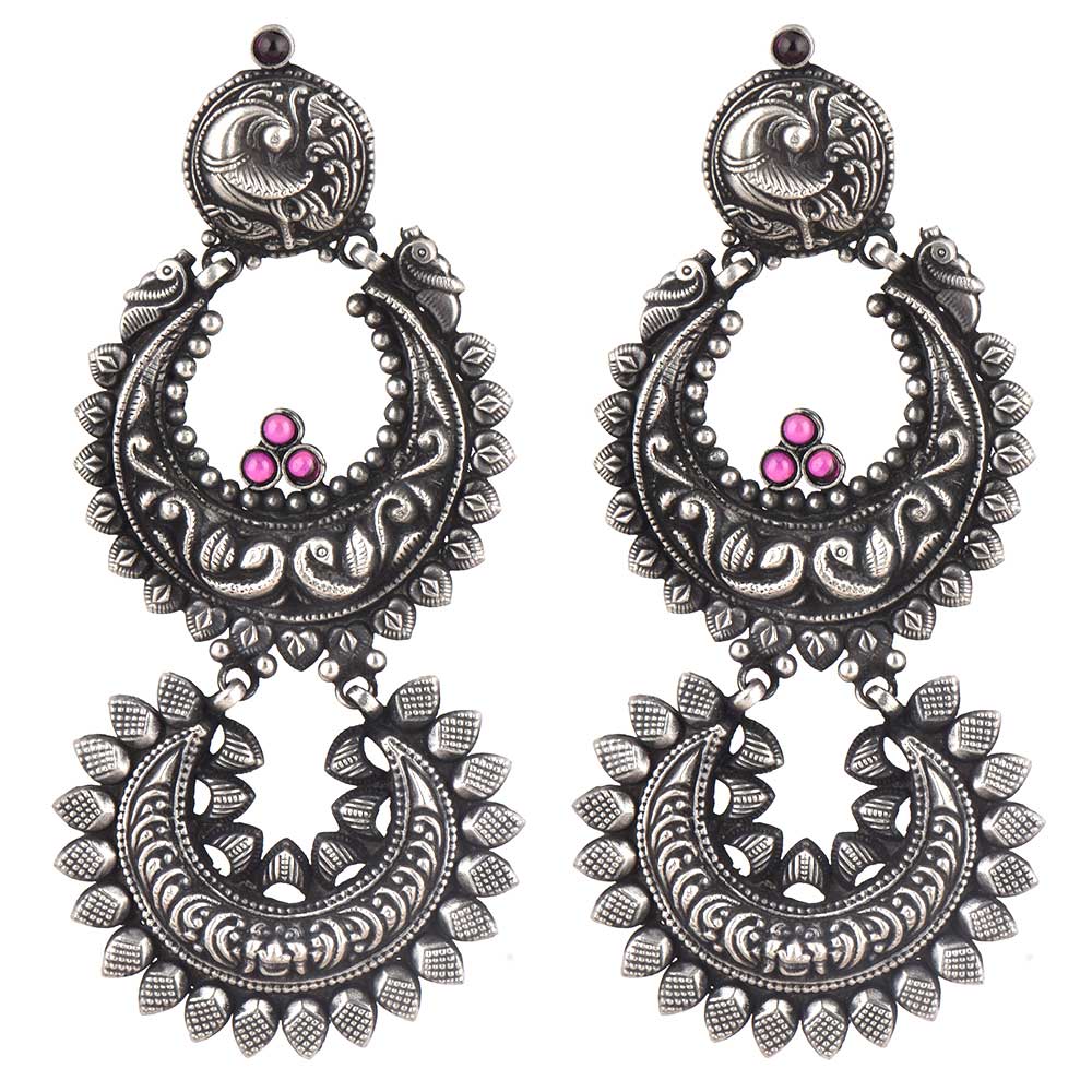 Side profile showing silver work on the dangle earrings