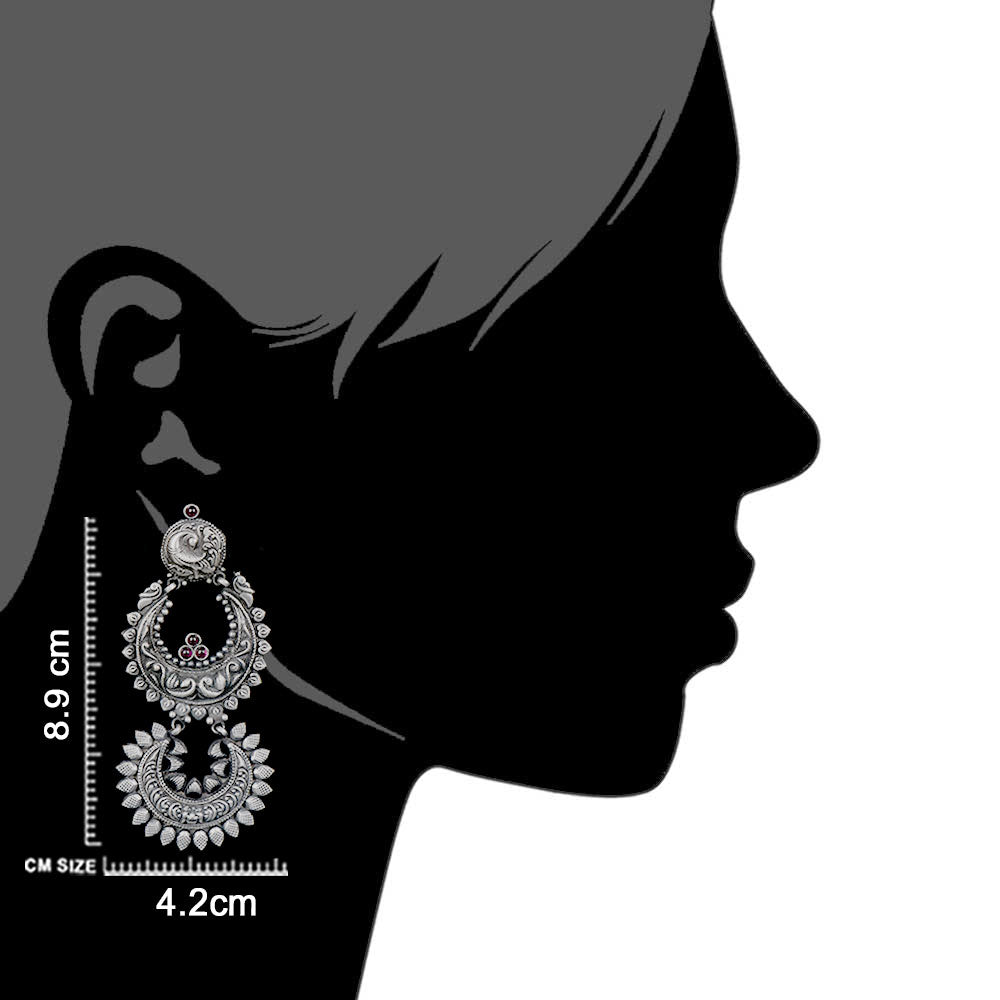 Artisan hands crafting the peacock dangle earrings