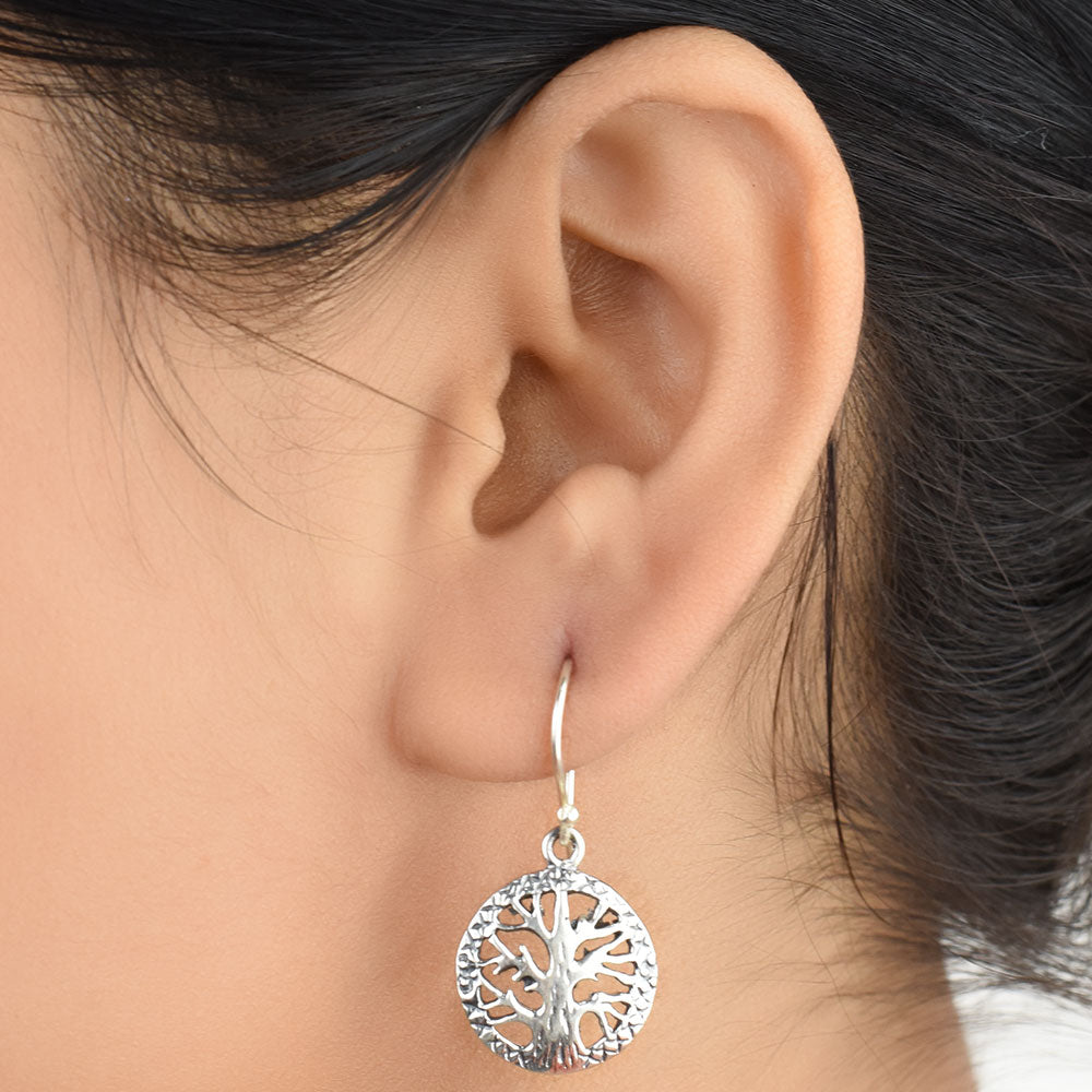 Front view of Reet cross stitch, round, tree earrings in 92.5 Sterling Silver